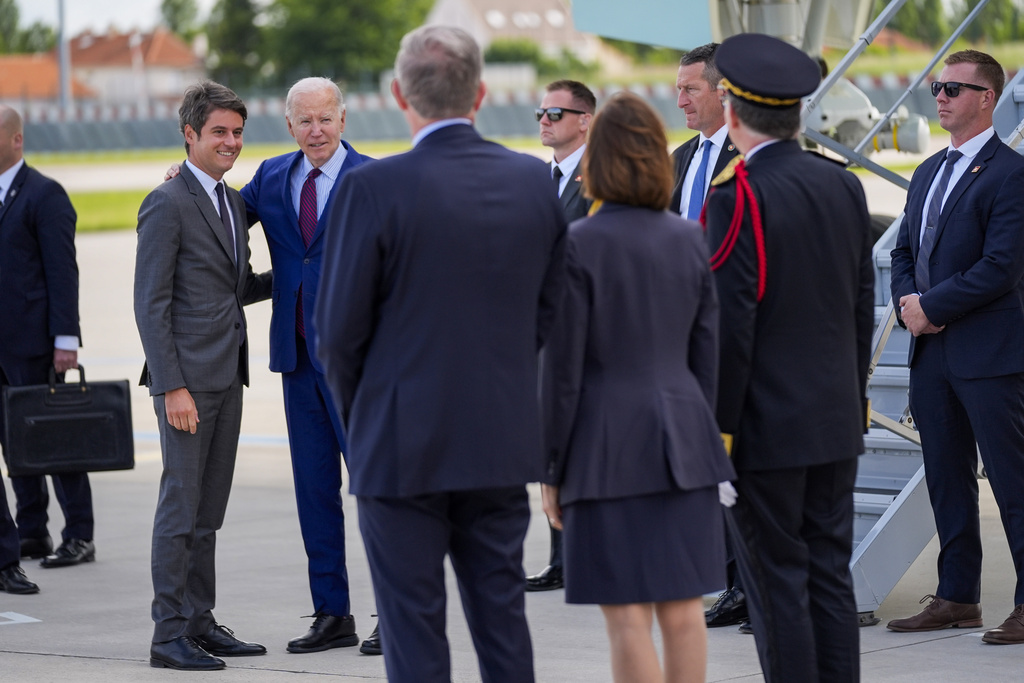 President Joe Biden is welcomed by France's Prime Minister Gabriel Attal, left, after arriving at Orly airport, south of Paris, Wednesday, June 5, 2024. Biden is in France to mark the 80th anniversary of D-Day.