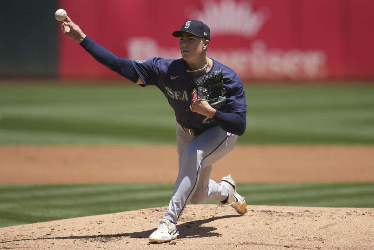 Seattle Mariners pitcher Bryan Woo works against the Oakland Athletics during the first inning of a baseball game in Oakland, Calif., Thursday, June 6, 2024.