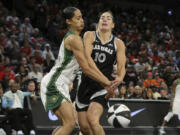 Seattle Storm guard Skylar Diggins-Smith knocks the ball away from Las Vegas Aces guard Kelsey Plum (10) during the first half of a WNBA basketball game in Las Vegas on Friday, June 7, 2024.