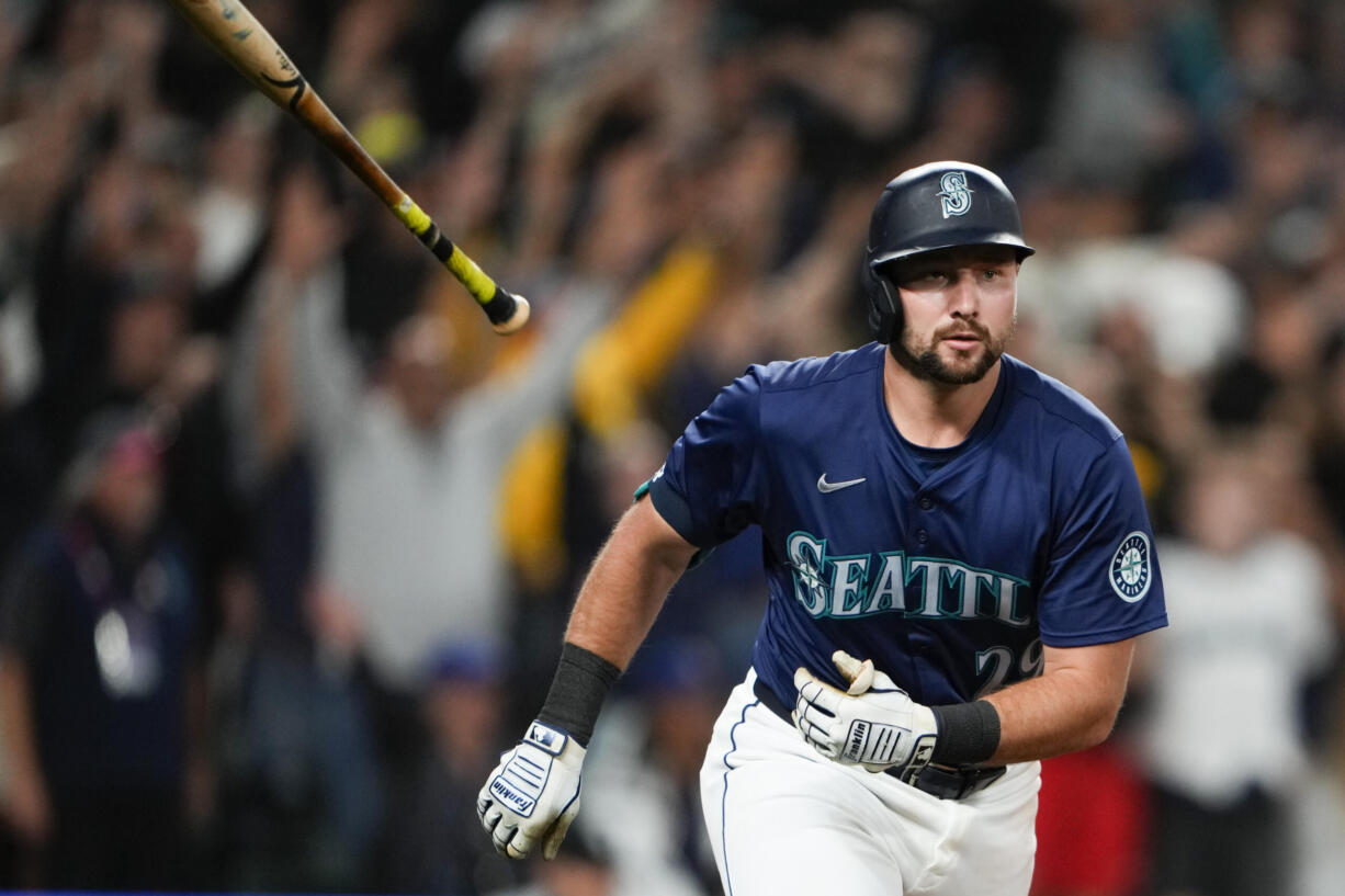 Seattle Mariners' Cal Raleigh flips his bat after hitting a game-winning grand slam against the Chicago White Sox during the ninth inning of a baseball game Monday, June 10, 2024, in Seattle.
