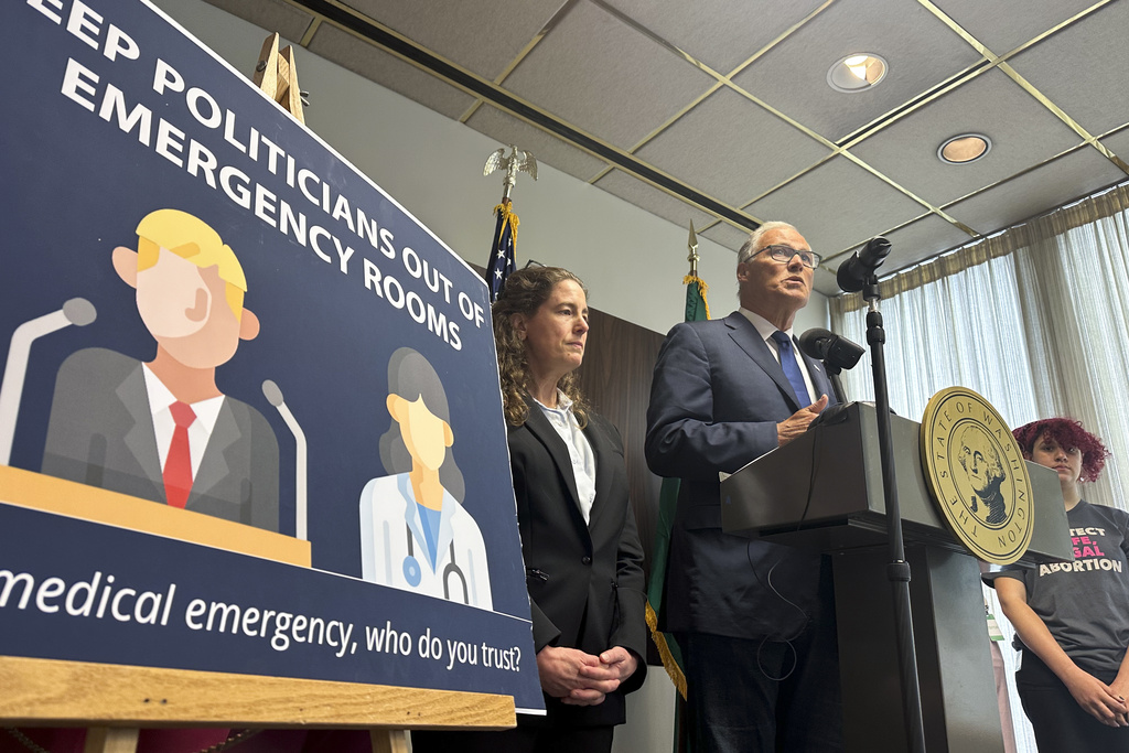 Washington Gov. Jay Inslee speaks to reporters during a news conference in Seattle, Tuesday, June 11, 2024, as abortion rights supporters listen. Inslee announced that Washington state will spell out in state law that hospitals must provide abortions if needed to stabilize patients, a step that comes as the U.S. Supreme Court is expected to rule this month on whether conservative states can bar abortions during some medical emergencies.