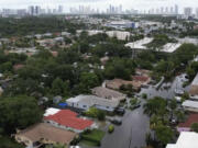 This aerial view taken from video shows a flooded street in Northeast Miami-Dade County, Fla., on Thursday, June 13, 2024. A tropical disturbance brought a rare flash flood emergency to much of southern Florida the day before. Floridians prepared to weather more heavy rainfall on Thursday and Friday.