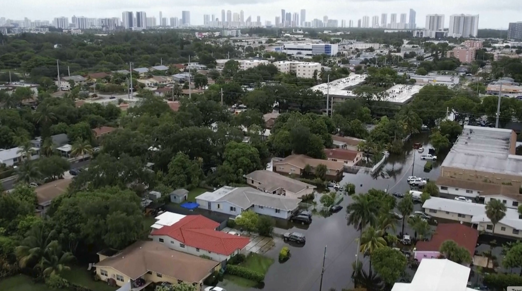 This aerial view taken from video shows a flooded street in Northeast Miami-Dade County, Fla., on Thursday, June 13, 2024. A tropical disturbance brought a rare flash flood emergency to much of southern Florida the day before. Floridians prepared to weather more heavy rainfall on Thursday and Friday.