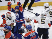 Florida Panthers goalie Sergei Bobrovsky (72) looks on as Edmonton Oilers' Zach Hyman (18) celebrates a goal during the second period of Game 4 of the NHL hockey Stanley Cup Final, Saturday, June 15, 2024, in Edmonton, Alberta.