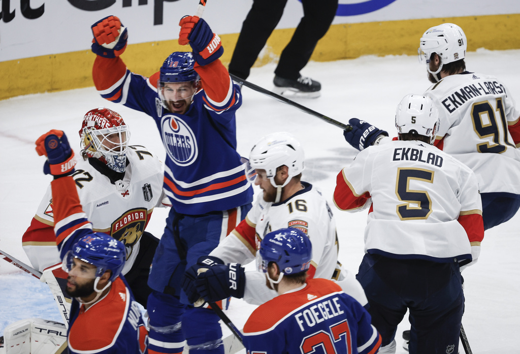 Florida Panthers goalie Sergei Bobrovsky (72) looks on as Edmonton Oilers' Zach Hyman (18) celebrates a goal during the second period of Game 4 of the NHL hockey Stanley Cup Final, Saturday, June 15, 2024, in Edmonton, Alberta.