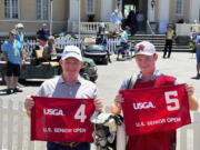 Frank Bensel, left, and his caddie and 14-year-old son, Hagen, pose with hole 4 and 5 flags after Bensel turned up a pair of aces on the back-to-back holes during the second round of the U.S. Senior Open golf tournament in Newport, R.I., Friday, June 28, 2024.