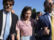 Amanda Knox arrives flanked by her husband Christopher Robinson, right, at the Florence courtroom in Florence, Italy, Wednesday, June 5, 2024. Amanda Knox returns to an Italian courtroom Wednesday for the first time in more than 12&frac12; years to clear herself &ldquo;once and for all&rdquo; of a slander charge that stuck even after she was exonerated in the brutal 2007 murder of her British roommate in the idyllic hilltop town of Perugia.