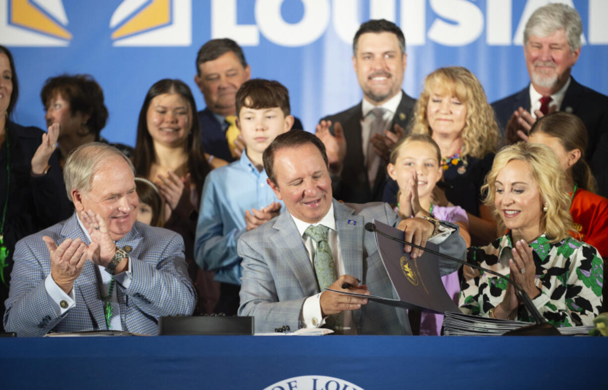 Louisiana Gov. Jeff Landry signs bills related to his education plan on Wednesday, June 19, 2024, at Our Lady of Fatima Catholic School in Lafayette, La. Louisiana has become the first state to require that the Ten Commandments be displayed in every public school classroom, the latest move from a GOP-dominated Legislature pushing a conservative agenda under a new governor.