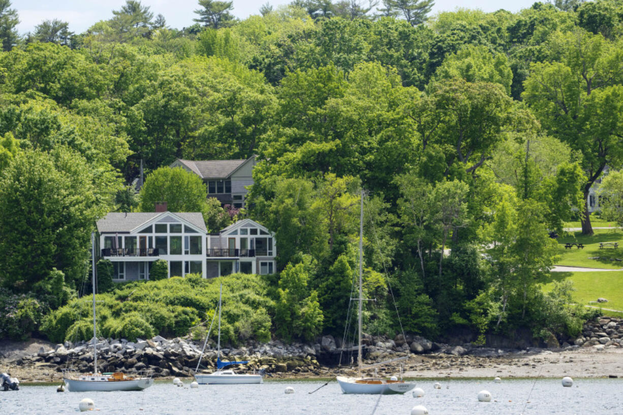 The homes of Lisa Gorman, front, and Amelia and Arthur Bond are seen June 4 in Camden, Maine. The Bonds &mdash; a wealthy, politically connected Missouri couple &mdash; allegedly poisoned their neighbor&rsquo;s trees to secure a view of Camden Harbor, outraging residents in the seaside community. (Photos by Robert F.