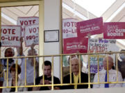 FILE - Protesters on both sides of the issue hold signs as North Carolina House members debate, May 16, 2023, in Raleigh, N.C. On Monday, June 3, 2024, a federal judge permanently blocked some efforts in North Carolina to restrict how abortion pills can be dispensed, saying they are unlawfully in conflict with the authority of the U.S. Food and Drug Administration. But she allowed other state laws to remain in effect, granting only a partial victory to a doctor who sued.