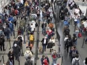 FILE - Passengers wait in a security line at Denver International Airport on Wednesday, Feb. 22, 2023. The TSA expects to break the 3 million mark on Friday, as many Americans get an early start on their July 4 travel plans. It&rsquo;s just the start of what promises to be a busy summer.