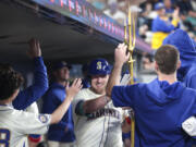 Seattle Mariners&#039; Luke Raley, center, celebrates in the dugout after hitting a home run off Los Angeles Angels starting pitcher Griffin Canning during the fourth inning of a baseball game, Sunday, June 2, 2024, in Seattle.