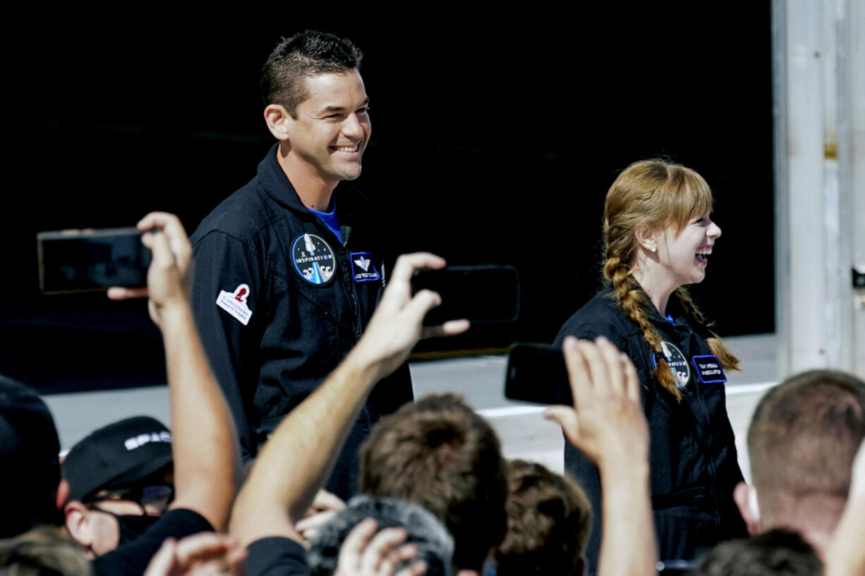 Jared Isaacman, left, and Hayley Arceneaux prepare to head to a launchpad Sept. 15, 2021, for a launch on a SpaceX Falcon 9 at the Kennedy Space Center in Cape Canaveral, Fla. New research presents the largest set of information yet regarding how the human body reacts to spaceflight.