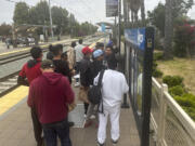 Migrants released with notices to appear in immigration court wait for a train to the San Diego International Airport in San Diego, Calif., Thursday, June 6, 2024. President Joe Biden has suspended asylum processing at the U.S. border under a new policy unveiled this week. But the proclamation has an exception for &ldquo;operational considerations.&rdquo;  The Homeland Security Department said in a detailed document outlining the ban that &ldquo;demographics and nationalities encountered at the border significantly impact&rdquo; its ability to deport people.