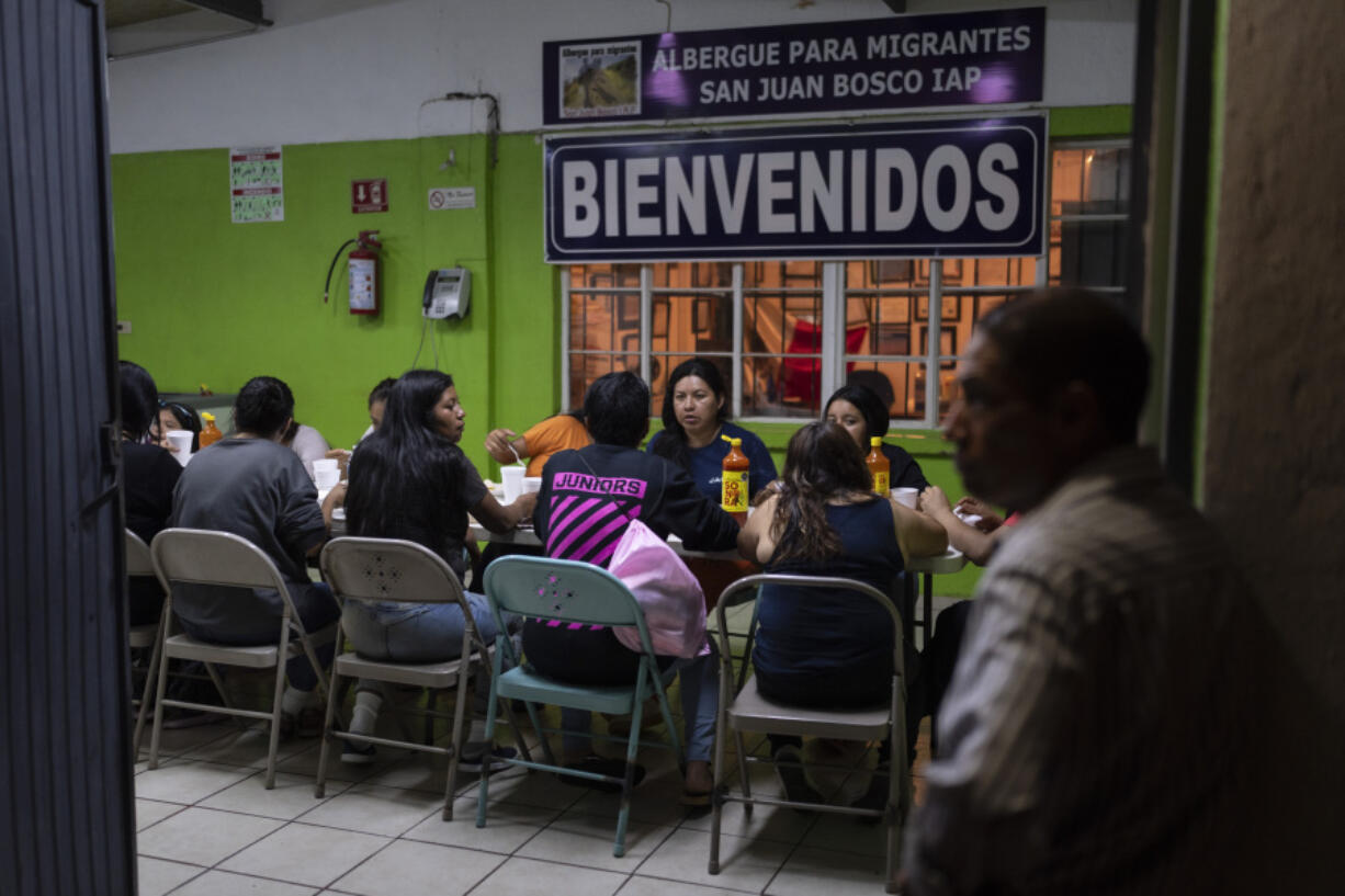 Female migrants, mostly Mexican nationals recently deported from the U.S., eat their dinner at the San Juan Bosco migrant shelter in Nogales, Mexico, Tuesday, June 25, 2024. Many migrants who fail interviews are deported to Nogales, a sprawling city in the Mexican state of Sonora, and end up at the shelter, where a giant fan in a former chapel offers relief from blistering summer heat. (AP Photo/Jae C.