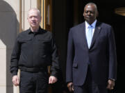 Defense Secretary Lloyd Austin, standing right, and Israeli Defense Minister Yoav Gallant, standing left, listen to the playing of the Israeli National Anthem during an arrival ceremony at the Pentagon in Washington, Tuesday, June 25, 2024. The two, who have been in weekly contact since the Hamas attack on Israel in October, are expected to discuss Israeli operations in Gaza, humanitarian efforts in the region, and tension with Hezbollah in Lebanon.