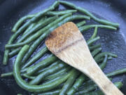 Green beans picked from a home garden are cooked in a saute pan in Chatham, Mass. Nutrition experts say you can improve your health by eating whatever fruits and vegetables are in season.