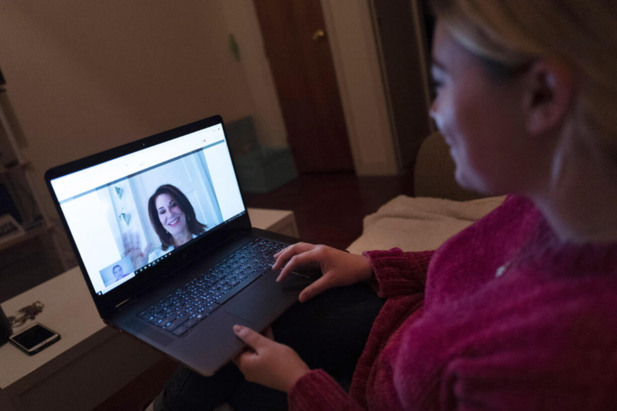 A patient sits in her apartment Jan. 14, 2019, in the Brooklyn borough of New York during a telemedicine video conference with a physician.