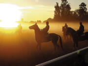 FILE &mdash; A fog burns off as the sun rises over the Oklahoma Training Track, in Saratoga Springs, N.Y., Aug. 26, 2005. Venerable Saratoga Race Course adds to its mystique and tradition by hosting the Belmont Stakes for the next two years. The track that predates the end of the U.S. Civil War has never before hosted a Triple Crown race.