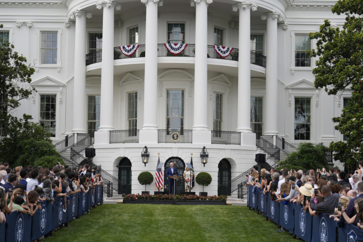 President Joe Biden, accompanied by first lady Jill Biden, speaks during a Congressional picnic on the South Lawn of the White House in Washington, Tuesday, June 4, 2024.