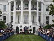 President Joe Biden, accompanied by first lady Jill Biden, speaks during a Congressional picnic on the South Lawn of the White House in Washington, Tuesday, June 4, 2024.