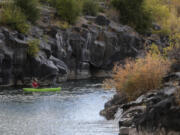 FILE - A man hooks a fish on the Snake River in Idaho Falls, Idaho, on Sunday, Oct. 11, 2020. The U.S. government on Tuesday, June 18, 2024, acknowledged for the first time the harms that the construction and operation of dams on the Columbia and Snake rivers in the Pacific Northwest have caused Native American tribes, issuing a report that details how the unprecedented structures devastated salmon runs, inundated villages and burial grounds, and continue to severely curtail the tribes' ability to exercise their treaty fishing rights.