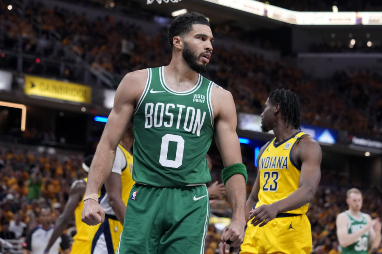 Boston Celtics forward Jayson Tatum (0) reacts after making a basket during the first half of Game 4 of the NBA Eastern Conference basketball finals against the Indiana Pacers, Monday, May 27, 2024, in Indianapolis.