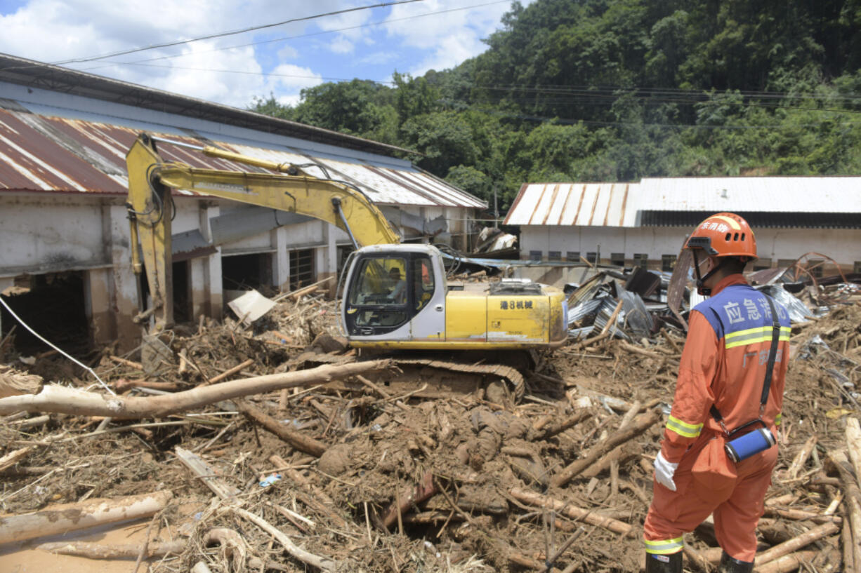 In this photo released by Xinhua News Agency, rescuers clear debris in a flood-affected area in Sishui Township of Pingyuan County, Meizhou City, southern China&rsquo;s Guangdong Province, June 20, 2024. Several people have died and others are missing after downpours caused historic flooding in rural parts of Guangdong province in southern China, while authorities warned Friday of more flooding ahead in other parts of the country.