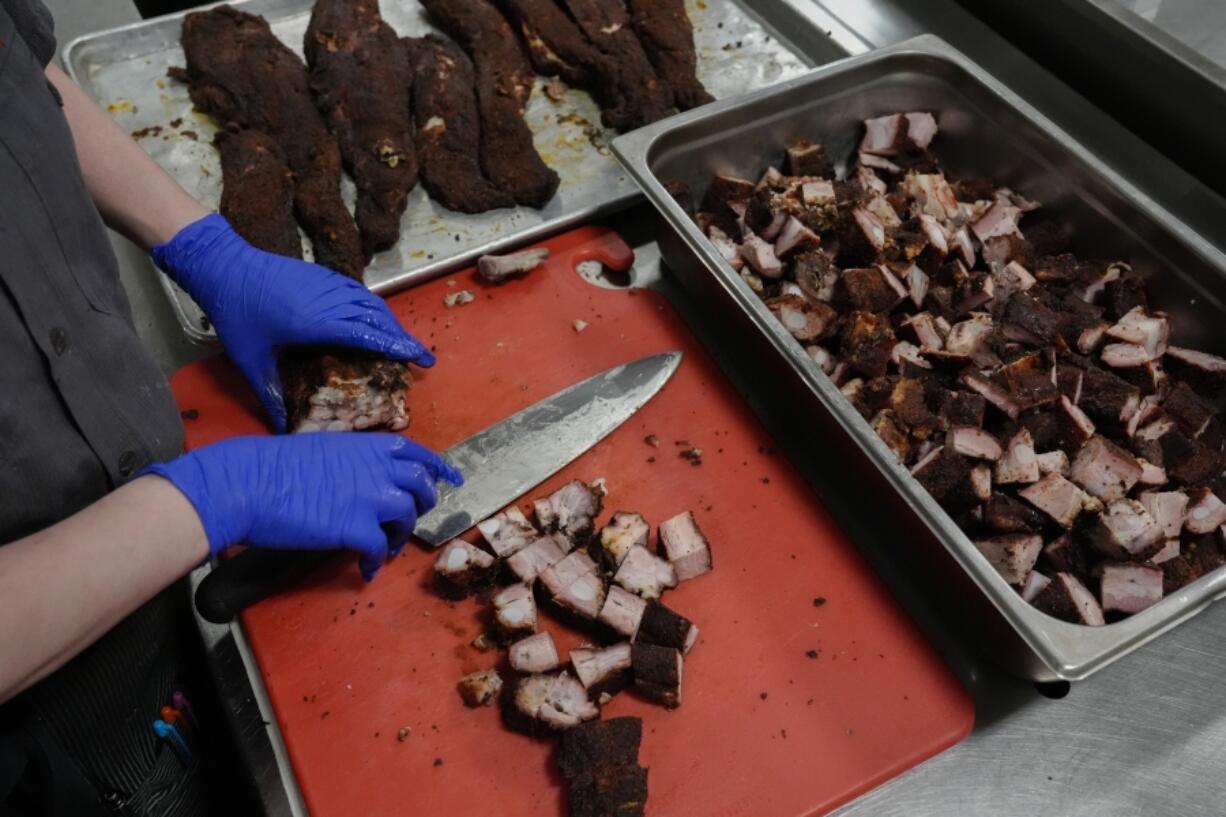 A cook prepares pork rib tips, Wednesday, June 12, 2024, at a barbecue restaurant in Cincinnati. Psychologists have known for years now that men tend to eat more meat than women, but a study of people around the world now reveals that that&rsquo;s true across cultures. (AP Photo/Joshua A. Bickel) (Photos by Joshua A.