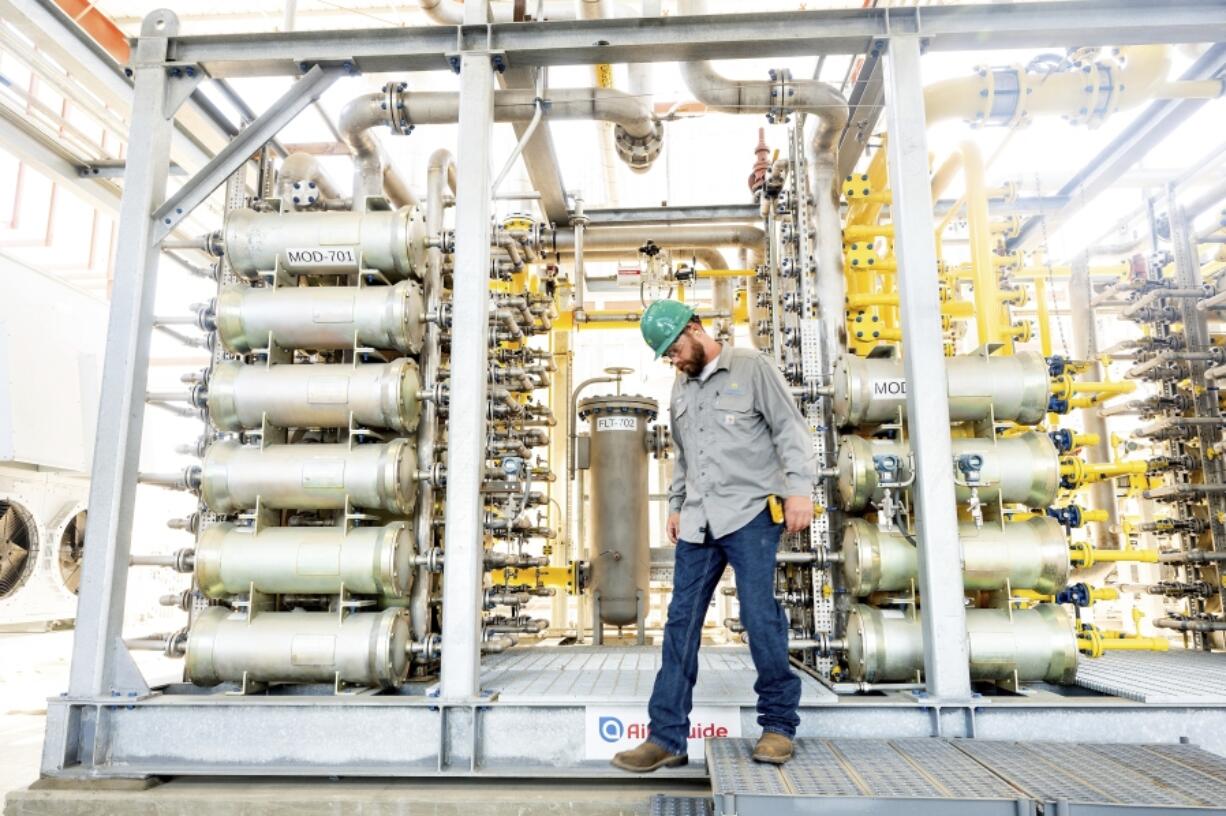 Andrew Zipser checks operations at an Aemetis biogas facility in Ceres, Calif., on Thursday, May 9, 2024. Local dairies use digesters to capture methane from cow manure which is then piped to the facility for processing.