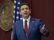 FILE - Florida Gov. Ron DeSantis gives his State of the State address during a joint session of the Senate and House of Representatives in Tallahassee, Fla., Jan. 9, 2024. Months after Disney DeSantis&rsquo; appointees agreed to end a protracted legal fight, the two sides are set to approve an agreement Wednesday, June 5, that could result in the company investing $17 billion into its Florida resort and opens the door to a fifth major theme park at Walt Disney World.