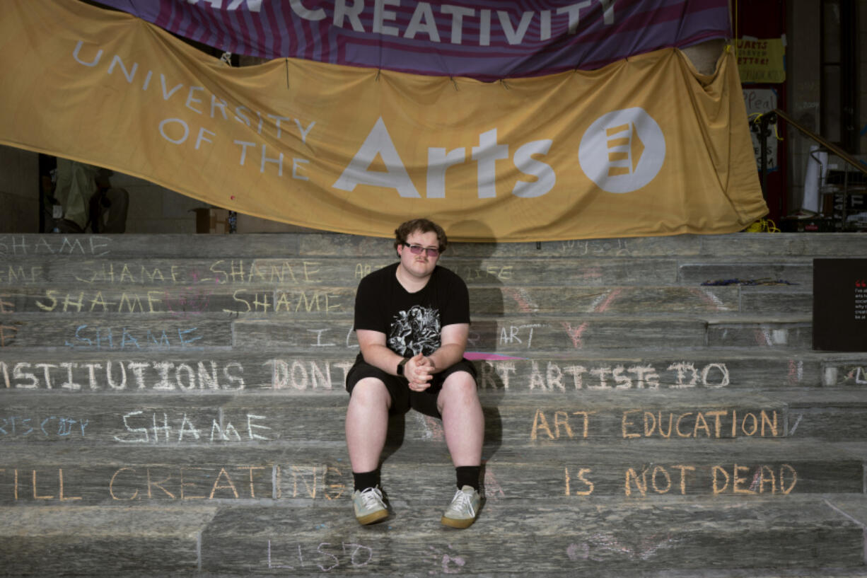 Rising sophomore Ian Callaghan-Kenna, 19, sits on the steps of Dorrance Hamilton Hall at the University of the Arts, Friday, June 14, 2024, in Philadelphia. Students at the university were thrown into panic mode two weeks ago, as they got the startling news that their school would be shutting down within days. Callaghan-Kenna, a film major, who commuted by bus to the university, has been coping with bouts of intense anxiety &mdash; not least because the college already has thousands of dollars of his federal aid for the fall term. He has joined a potential class-action lawsuit against the school.