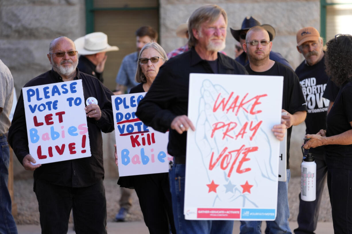 FILE - Anti-abortion supporters stand outside at the Arizona capitol, May 1, 2024, in Phoenix. Reeling from a string of defeats, anti-abortion groups and their Republican allies in state governments across the country are deploying an array of strategies to counter proposed ballot initiatives intended to protect reproductive rights or prevent voters from having a say in the fall.