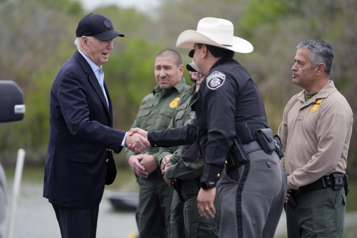 FILE - President Joe Biden talks with the U.S. Border Patrol and local officials, as he looks over the southern border, Feb. 29, 2024, in Brownsville, Texas, along the Rio Grande. Over the course of two weeks, President Joe Biden has imposed significant restrictions on immigrants seeking asylum in the U.S. and then offered potential citizenship to hundreds of thousands of people without legal status already living in the country. The two actions in tandem gives the president a chance to address one of the biggest vulnerabilities for his reelection campaign.