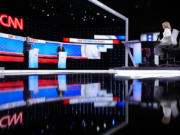 President Joe Biden, right, and Republican presidential candidate former President Donald Trump, left, during a presidential debate hosted by CNN, Thursday, June 27, 2024, in Atlanta. On the far right is CNN moderator Dana Bash.