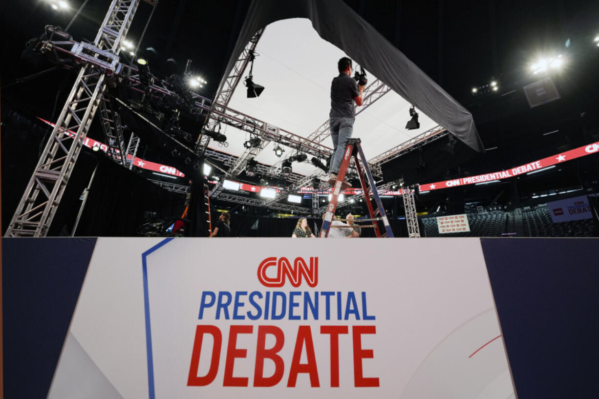 FILE - Ben Starett, lighting programmer for CNN, sets up lights in the spin room for the presidential debate between President Joe Biden and Republican presidential candidate former President Donald Trump in Atlanta, Wednesday, June 26, 2024.