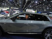 FILE - President Joe Biden drives a Cadillac Lyriq through the show room during a tour at the Detroit Auto Show Sept. 14, 2022, in Detroit. Former President Donald Trump and other Republicans portray Biden&rsquo;s policy to promote electric vehicles as unfair for consumers and government overreach. Biden and Democrats have been less vocal and more nuanced, advocating Biden&rsquo;s climate reduction goals while promoting homegrown technology over competition from China.