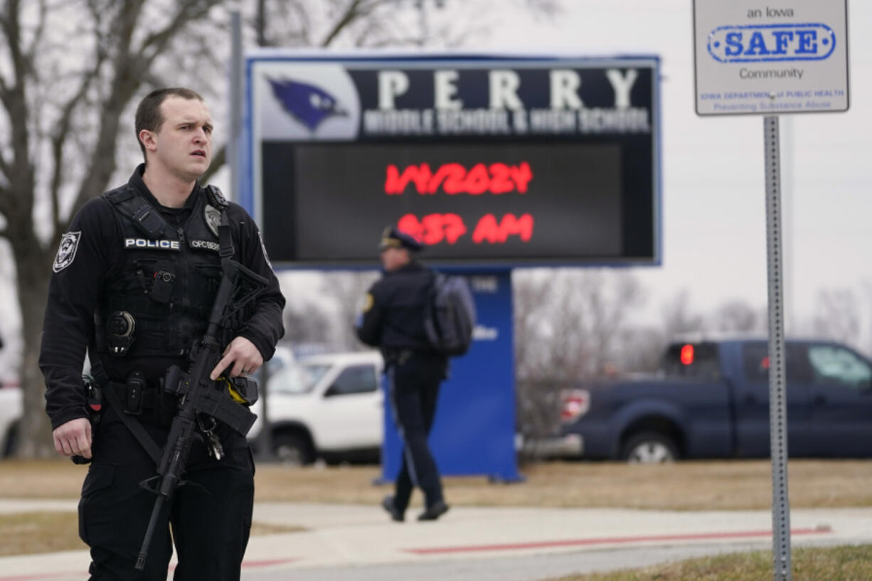 FILE - Police respond to Perry High School in Perry, Iowa, Jan. 4, 2024. Groups pushing tighter gun laws have been building political muscle through multiple elections, boosted by the outcry following mass shootings at schools and other public places, to say nothing of the nation&rsquo;s daily gun violence. Now, gun control advocates and many Democrats see additional openings created by hardline positions of the gun lobby and their most influential champion, former President Donald Trump.