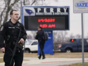 FILE - Police respond to Perry High School in Perry, Iowa, Jan. 4, 2024. Groups pushing tighter gun laws have been building political muscle through multiple elections, boosted by the outcry following mass shootings at schools and other public places, to say nothing of the nation&rsquo;s daily gun violence. Now, gun control advocates and many Democrats see additional openings created by hardline positions of the gun lobby and their most influential champion, former President Donald Trump.