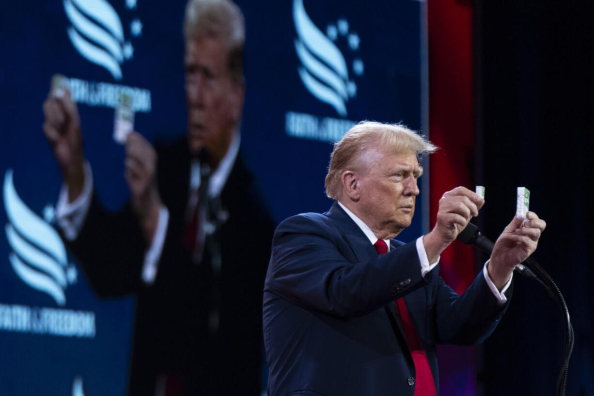 Republican presidential candidate former President Donald Trump holds up Tic Tacs as he discusses inflation at the Road to Majority conference in Washington, Saturday, June 22, 2024.