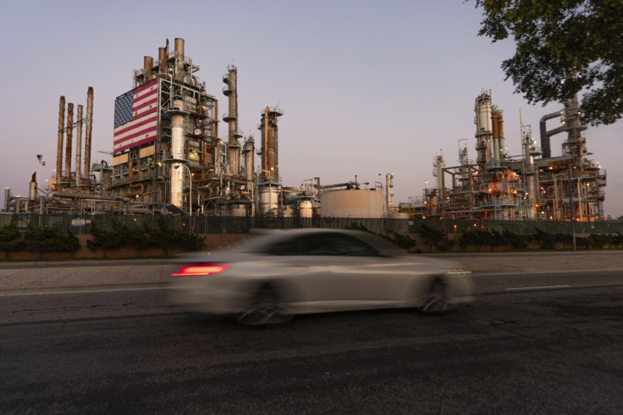 FILE - A car drives past Marathon Oil&rsquo;s Los Angeles Refinery complex in Carson, Calif., May 29, 2024. Gas prices are once again on the decline across the U.S. &mdash; bringing some ease to drivers now paying a little less to fill up their tanks.