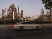 FILE - A car drives past Marathon Oil&rsquo;s Los Angeles Refinery complex in Carson, Calif., May 29, 2024. Gas prices are once again on the decline across the U.S. &mdash; bringing some ease to drivers now paying a little less to fill up their tanks.