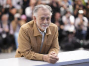 FILE - Director Francis Ford Coppola poses for photographers at the photo call for the film &ldquo;Megalopolis&rdquo; at the 77th international film festival, Cannes, southern France, Friday, May 17, 2024. Lionsgate will distribute &ldquo;Megalopolis&rdquo; in U.S. and Canadian theaters, the studio announced Monday, ending one of the biggest acquisition dramas of the year.