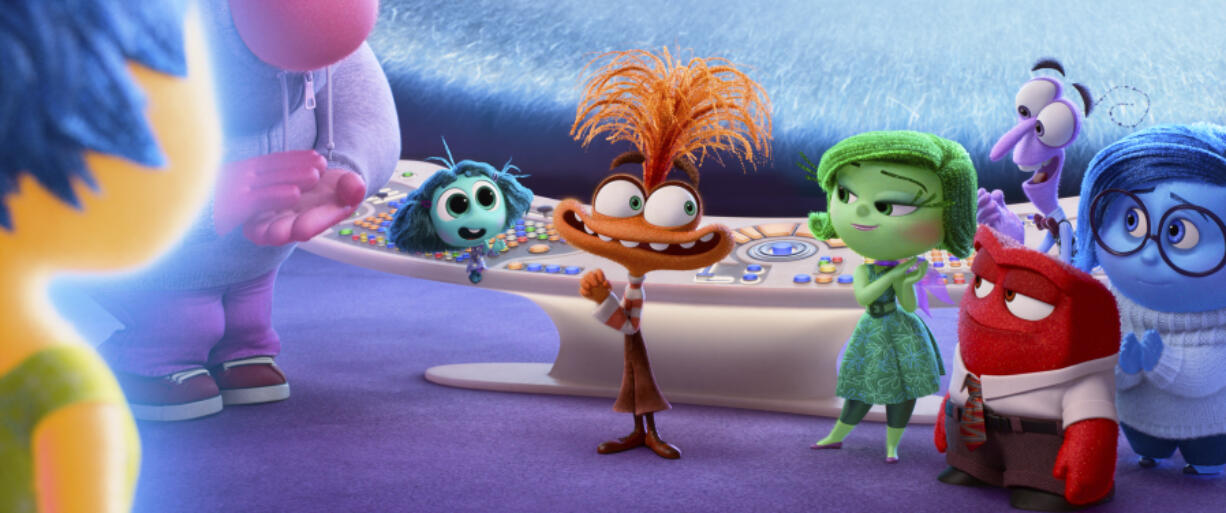 This image released by Disney/Pixar shows, from left, Joy, voiced by Amy Poehler, Embarrassment, voiced by Paul Walter Hauser,  Envy, voiced by Ayo Edebiri, Anxiety, voiced by Maya Hawke, Disgust, voiced by Liza Lapira, Anger,  voiced by Lewis Black (foreground), Fear, voiced by Tony Hale, and Sadness, voiced by Phyllis Smith, in a scene from &ldquo;Inside Out 2.&rdquo; (Disney/Pixar via AP)