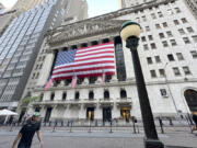 File - People pass the New York Stock Exchange on May 28, 2024, in New York. Global shares have advanced on Friday, June 28, 2024, as traders look ahead to a key report on inflation that could influence the Federal Reserve&rsquo;s next move on interest rates.