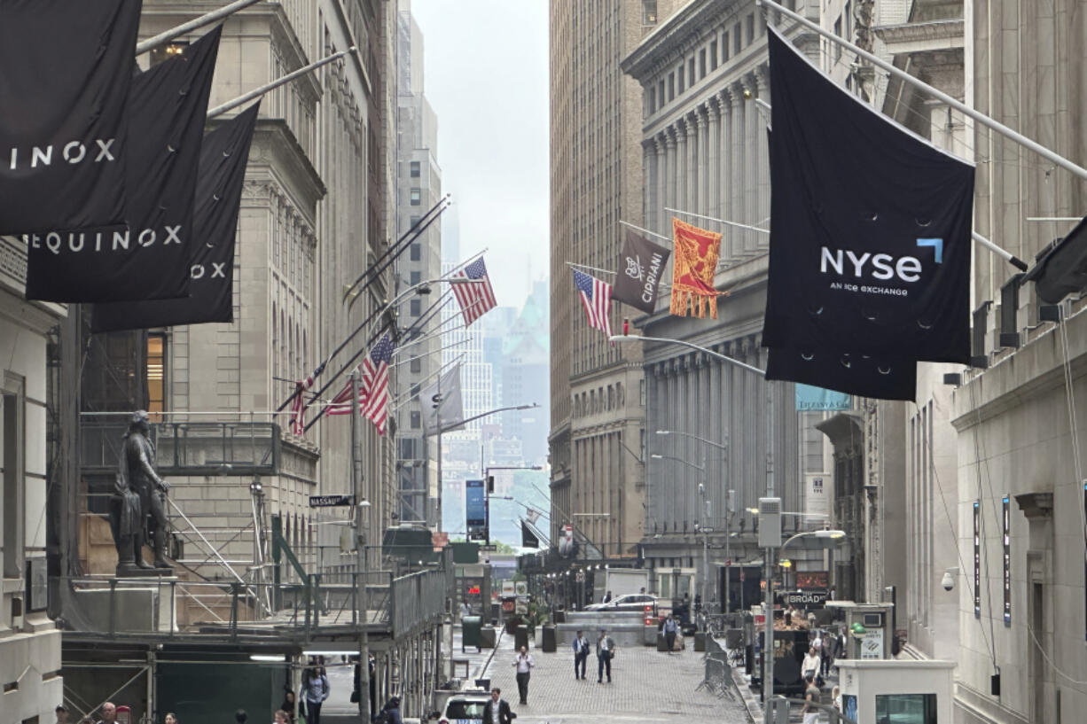 The New York Stock Exchange, right, is shown in this view looking east on Wall St. on Wednesday, June 5, 2024. Global shares are mixed as investors weigh data highlighting a slowing U.S. economy that offers both upsides and downsides for Wall Street.