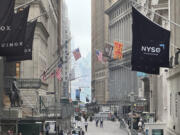 The New York Stock Exchange, right, is shown in this view looking east on Wall St. on Wednesday, June 5, 2024. Global shares are mixed as investors weigh data highlighting a slowing U.S. economy that offers both upsides and downsides for Wall Street.