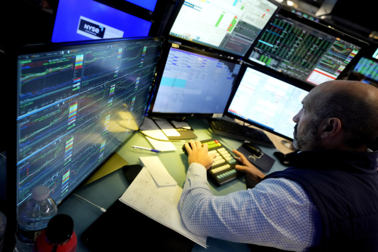 FILE - Specialist James Denaro works at his post on the floor of the New York Stock Exchange on June 12, 2024. Global shares were mixed on Friday, June 14, 2024, after Wall Street touched fresh records, with benchmarks pushed higher by the frenzy over artificial-intelligence technology.