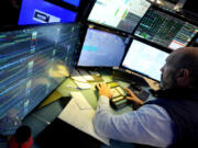 FILE - Specialist James Denaro works at his post on the floor of the New York Stock Exchange on June 12, 2024. Global shares were mixed on Friday, June 14, 2024, after Wall Street touched fresh records, with benchmarks pushed higher by the frenzy over artificial-intelligence technology.