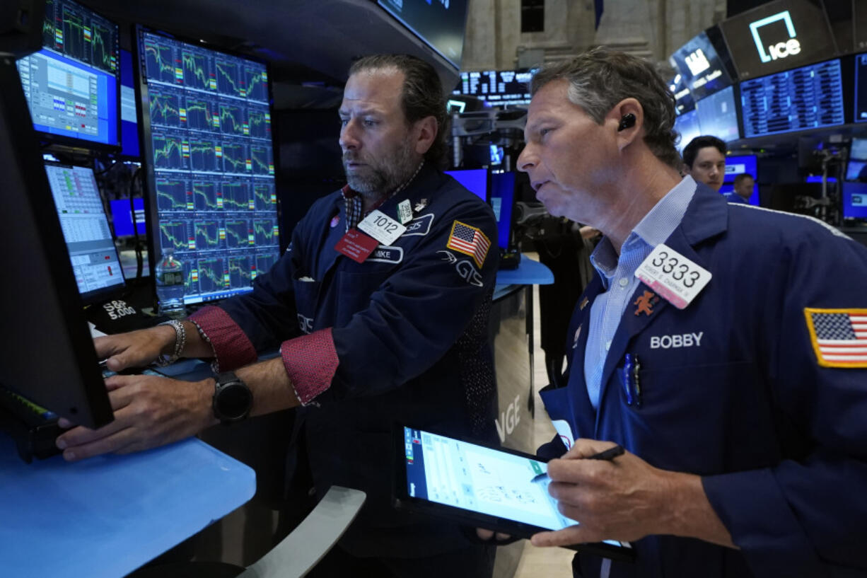 FILE - Specialist Michael Pistillo, left, and trader Robert Charmak work on the floor of the New York Stock Exchange, May 30, 2024. World shares began June mostly higher after a report showing that inflation in the U.S. is not worsening drove a rally on Wall Street.